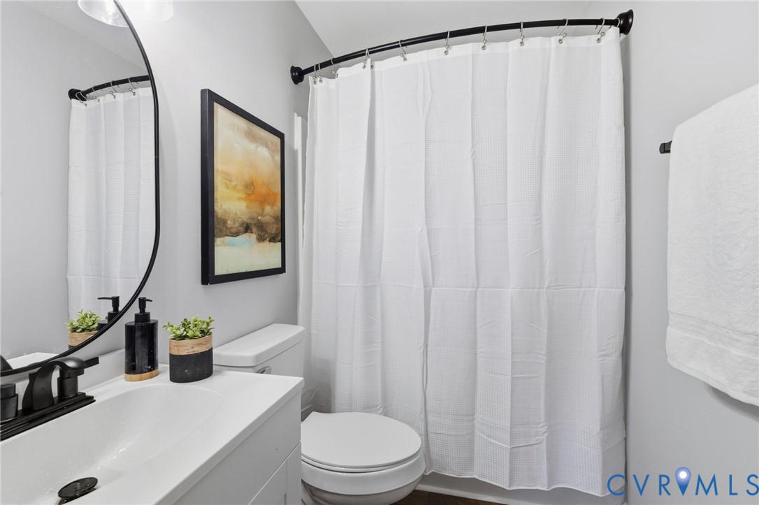 310 Stratton Street Crewe, VA 23930 - Photo 12 of 25 a bathroom with a toilet a sink and a mirror