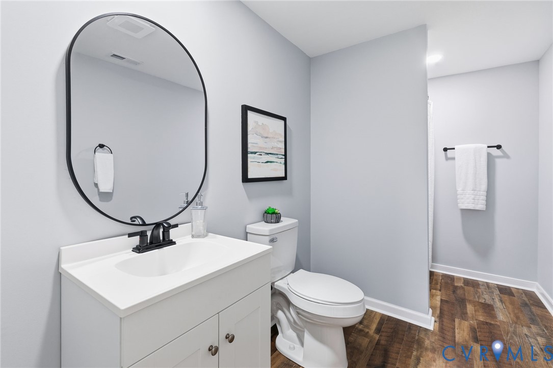 310 Stratton Street Crewe, VA 23930 - Photo 18 of 25 a bathroom with a sink a toilet and a mirror