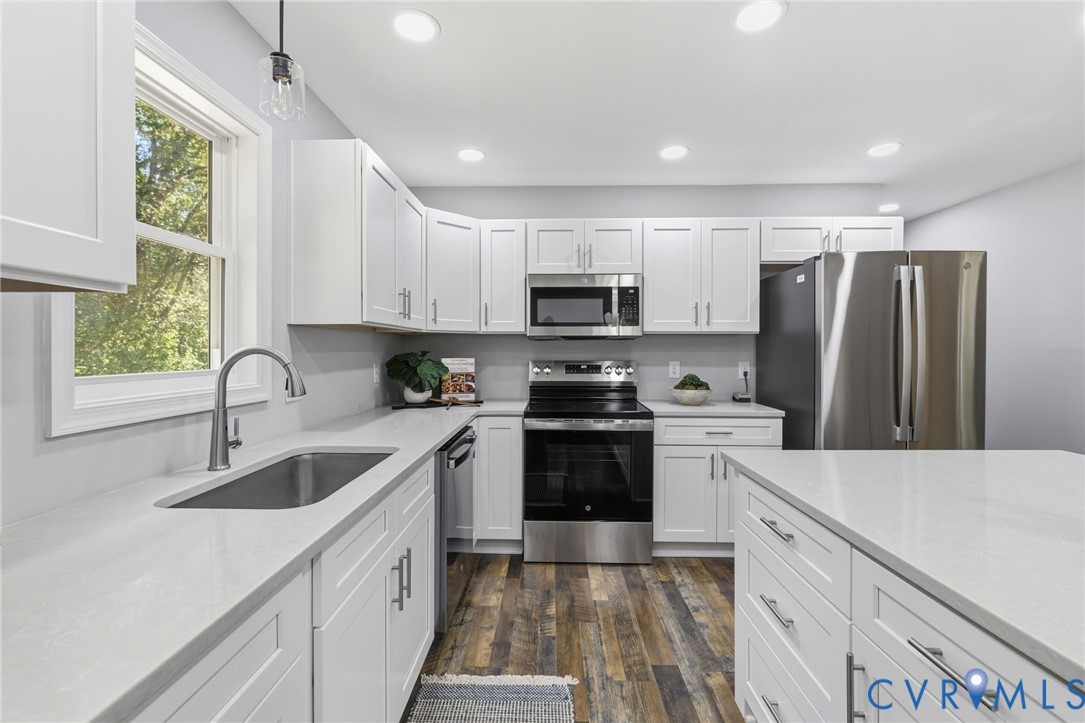 310 Stratton Street Crewe, VA 23930 - Photo 3 of 25 a kitchen with kitchen island granite countertop a sink stainless steel appliances and window