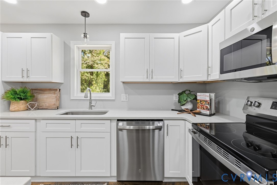 310 Stratton Street Crewe, VA 23930 - Photo 5 of 25 a kitchen with white cabinets and appliances