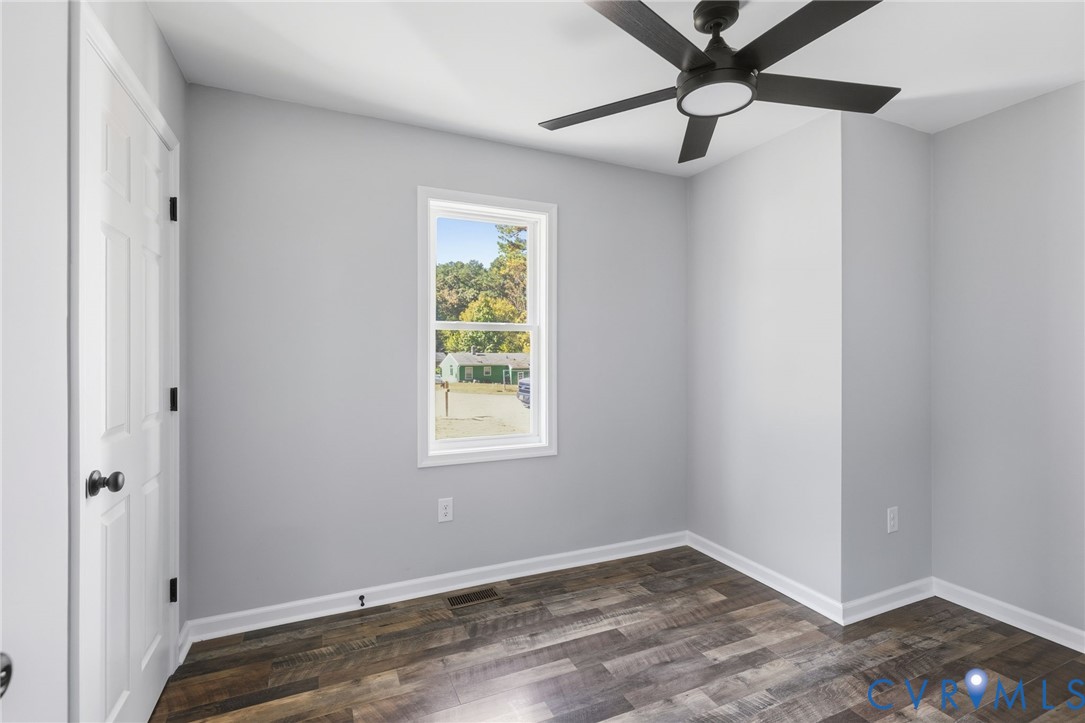 310 Stratton Street Crewe, VA 23930 - Photo 9 of 25 an empty room with a window and a ceiling fan