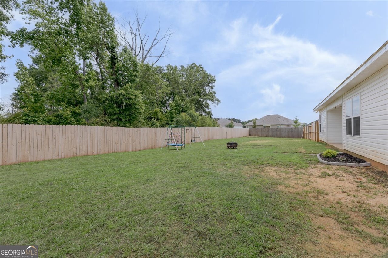 104 Meredith Layne Court Perry, GA 31069 - Photo 44 of 46 a backyard of a house with lots of green space