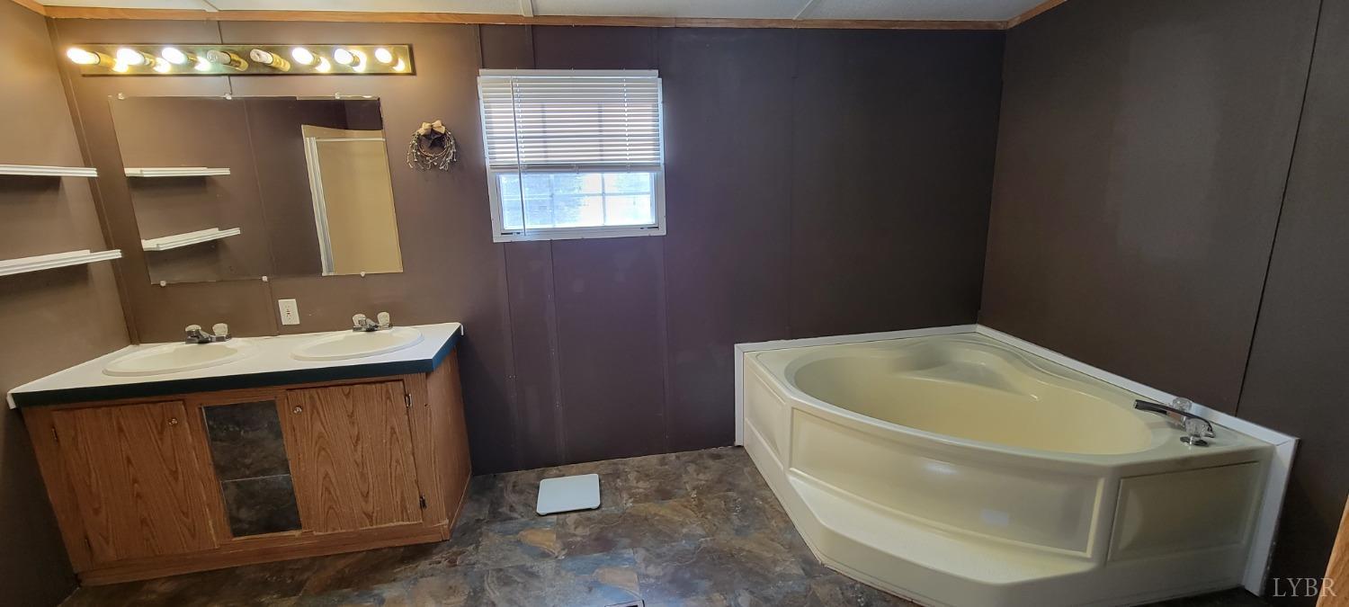 1015 Spring Mill Road Concord, VA 24538 - Photo 16 of 54 a bathroom with a sink a toilet and shower