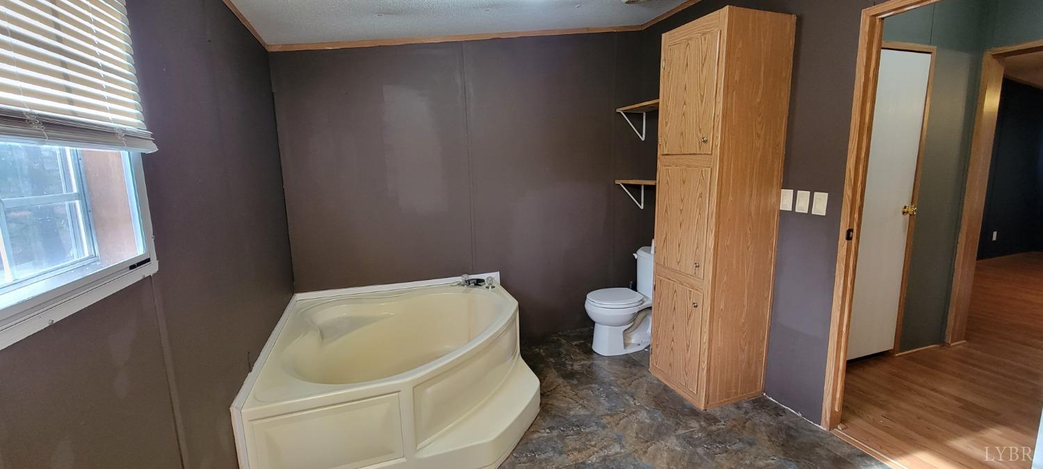 1015 Spring Mill Road Concord, VA 24538 - Photo 17 of 54 a white toilet sitting next to a bathroom sink