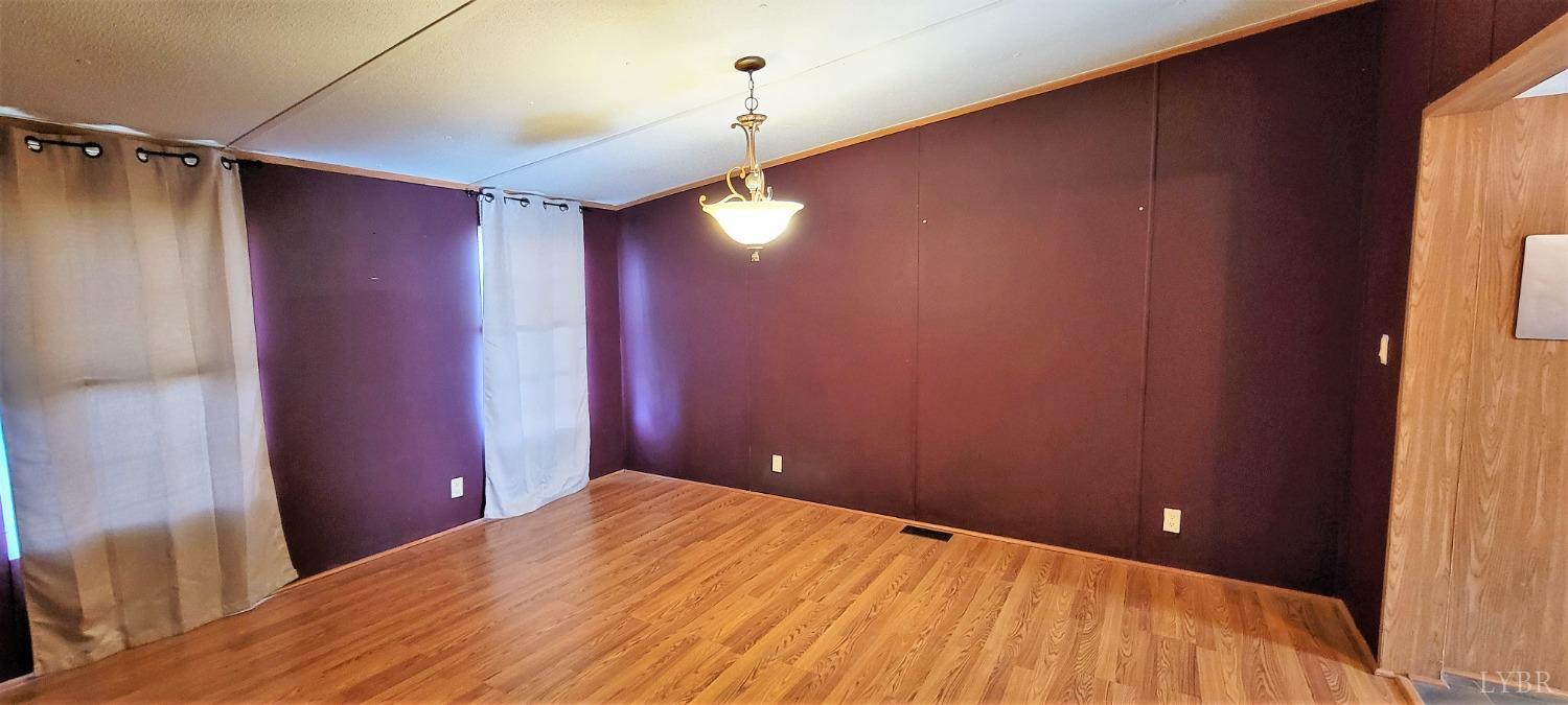 1015 Spring Mill Road Concord, VA 24538 - Photo 19 of 54 a bedroom with a bed and a chandelier fan