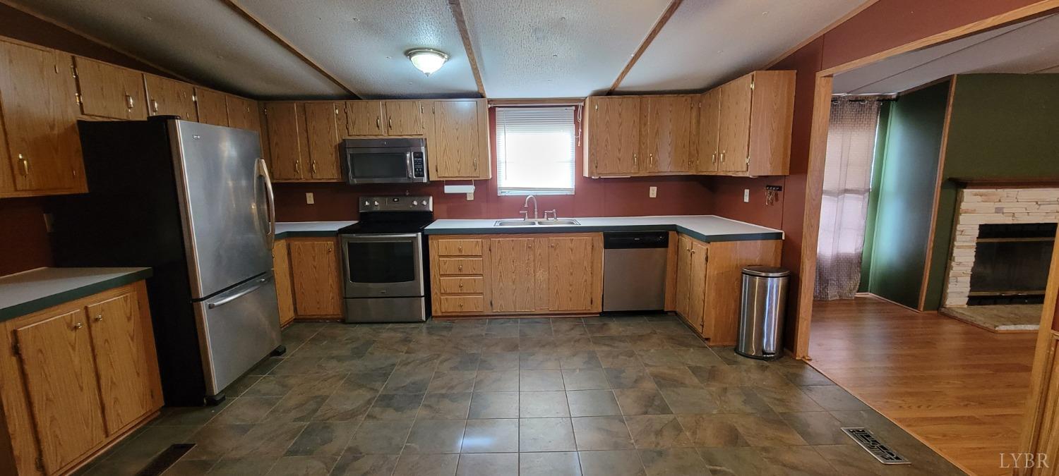 1015 Spring Mill Road Concord, VA 24538 - Photo 23 of 54 a kitchen with stainless steel appliances granite countertop a stove refrigerator sink and cabinets