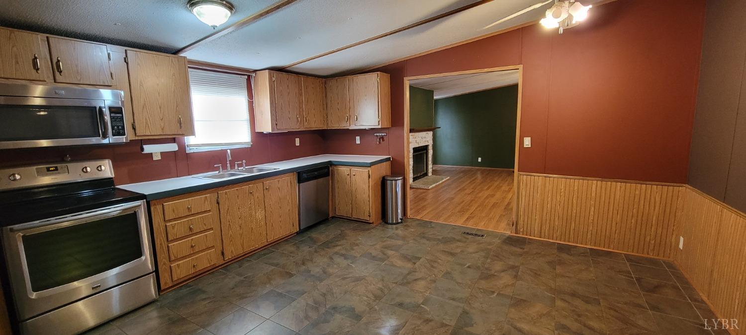 1015 Spring Mill Road Concord, VA 24538 - Photo 26 of 54 a kitchen with stainless steel appliances granite countertop a stove a sink and a microwave