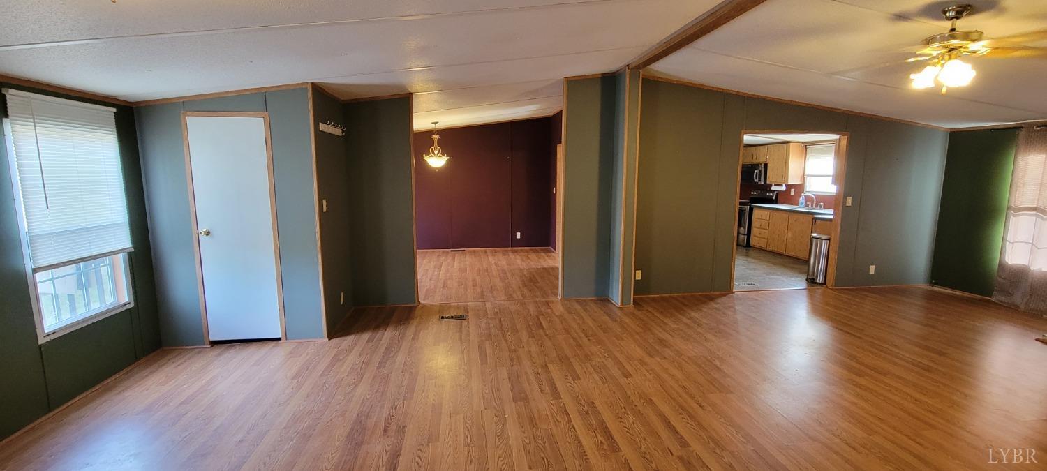 1015 Spring Mill Road Concord, VA 24538 - Photo 3 of 54 a view of a hallway with wooden floor and a living room