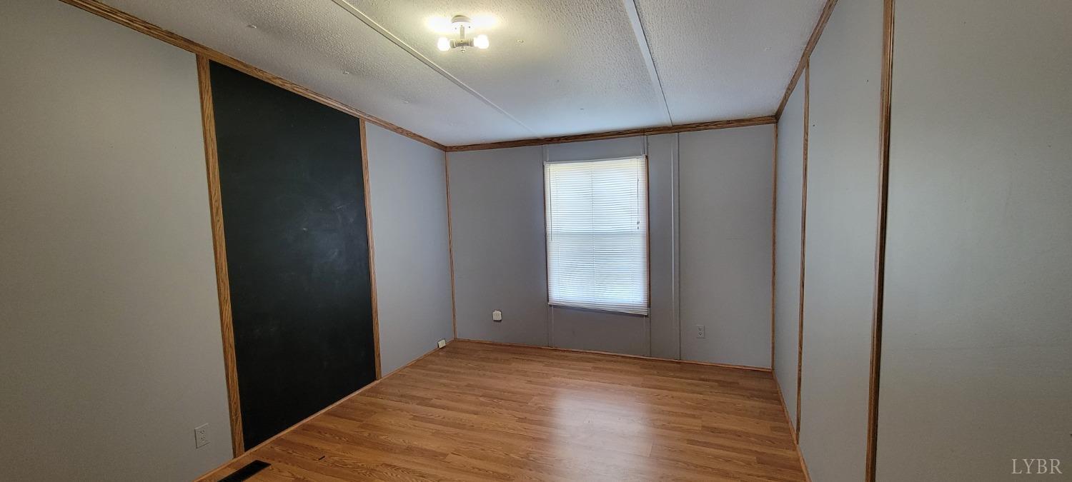 1015 Spring Mill Road Concord, VA 24538 - Photo 32 of 54 an empty room with wooden floor and windows