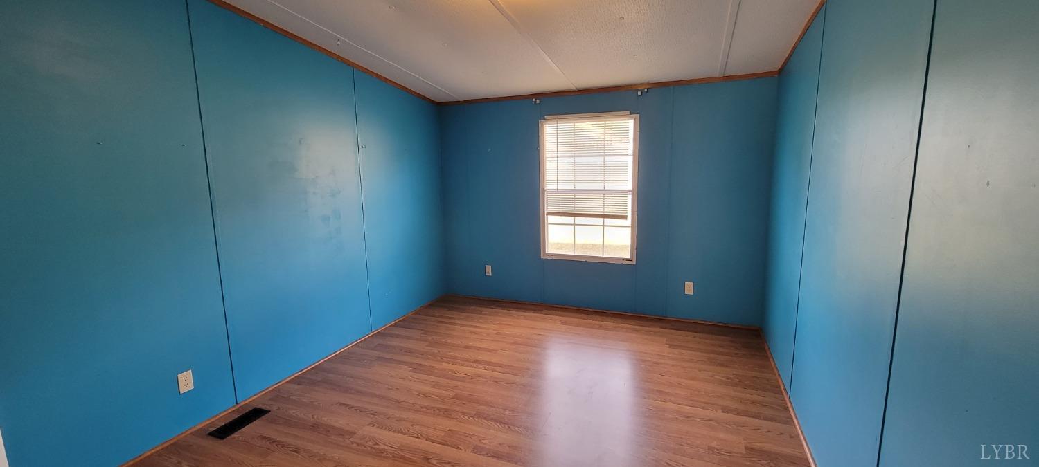 1015 Spring Mill Road Concord, VA 24538 - Photo 34 of 54 a view of an empty room with wooden floor and a window
