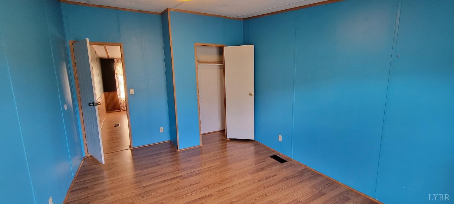 1015 Spring Mill Road Concord, VA 24538 - Photo 35 of 54 an empty room with wooden floor and closet