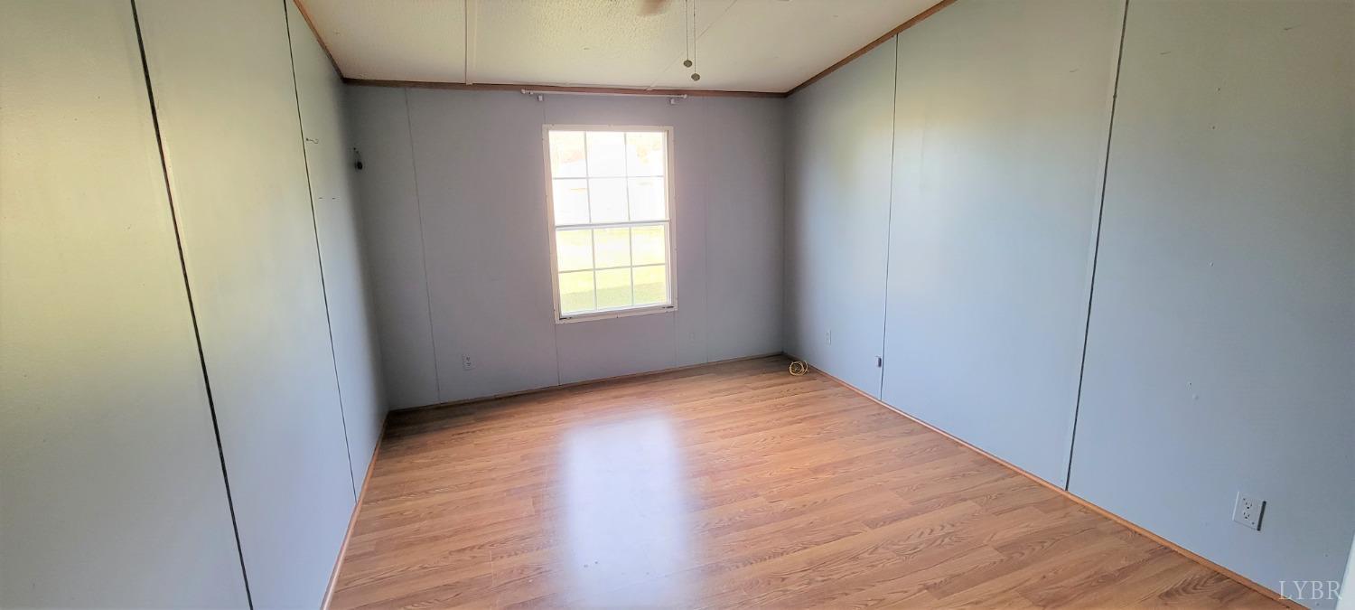 1015 Spring Mill Road Concord, VA 24538 - Photo 37 of 54 an empty room with wooden floor and windows
