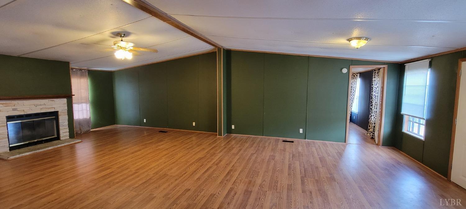 1015 Spring Mill Road Concord, VA 24538 - Photo 4 of 54 a view of an empty room with wooden floor and a fireplace