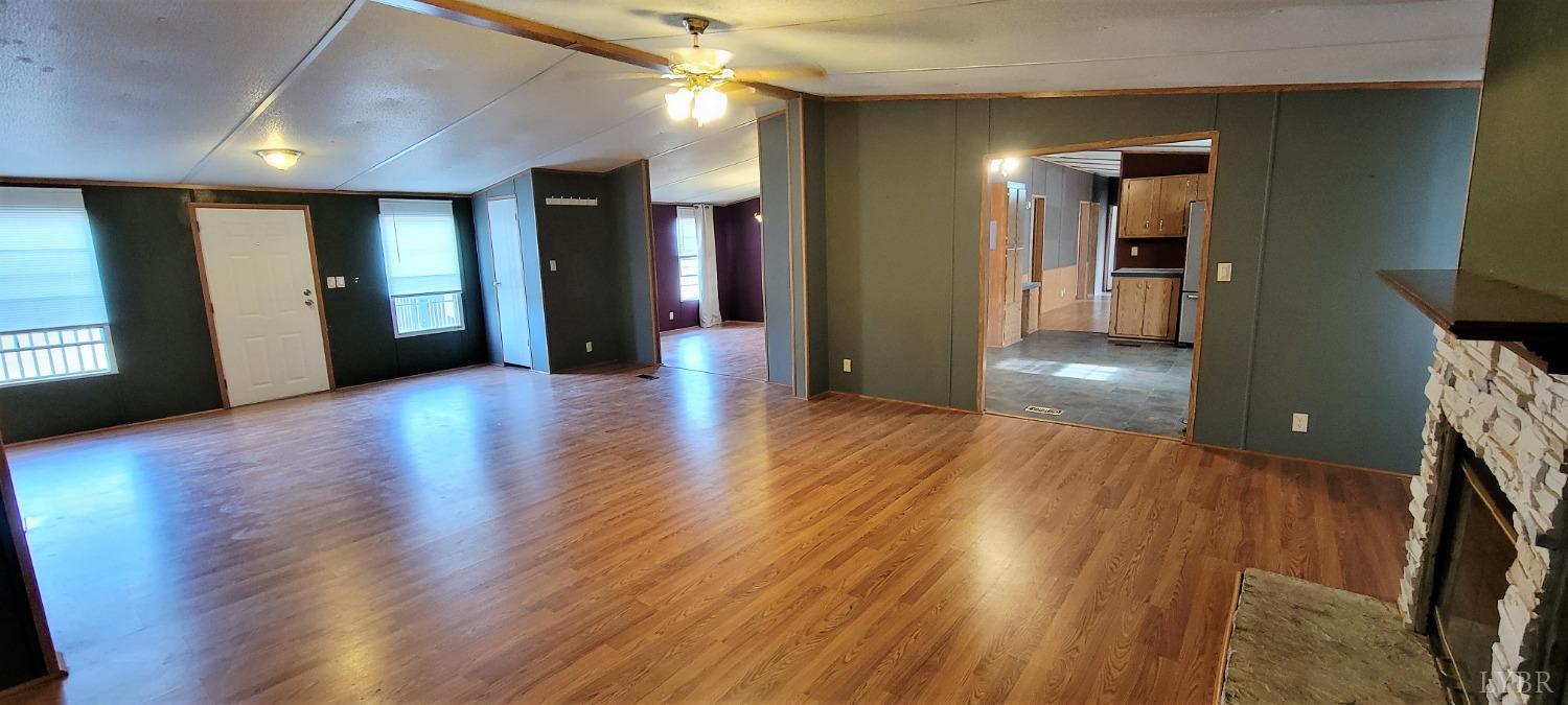 1015 Spring Mill Road Concord, VA 24538 - Photo 7 of 54 a view of a hallway with wooden floor and a living room