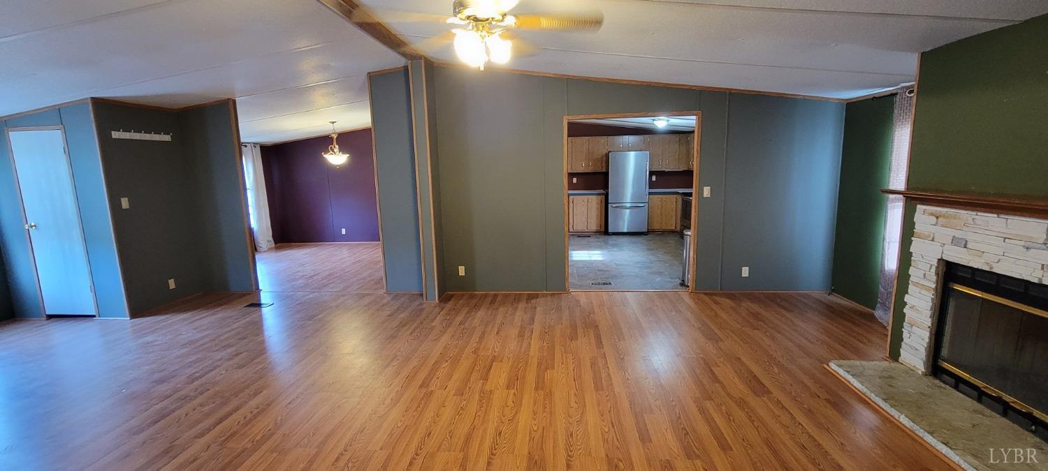 1015 Spring Mill Road Concord, VA 24538 - Photo 8 of 54 a view of a room with wooden floor and a kitchen