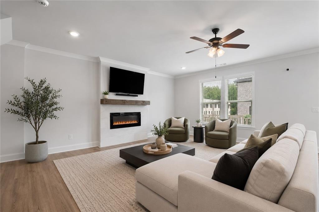 3334 Swallowtail Terrace Duluth, GA 30096 - Photo 20 of 37 a living room with furniture a fireplace and a flat screen tv