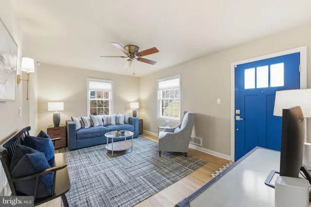 a view of a dining room with furniture and a chandelier