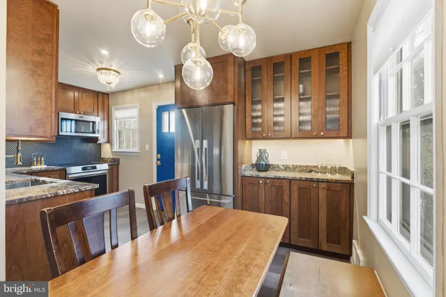 a kitchen with stainless steel appliances granite countertop a refrigerator and a sink