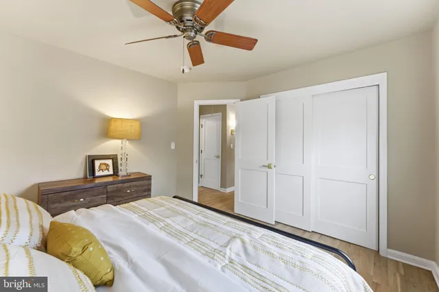 a bathroom with a granite countertop sink toilet a mirror and shower