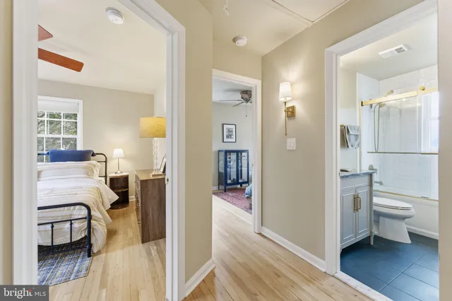 a living room with furniture and a book shelf