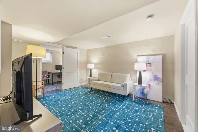 a view of a workspace with furniture and wooden floor