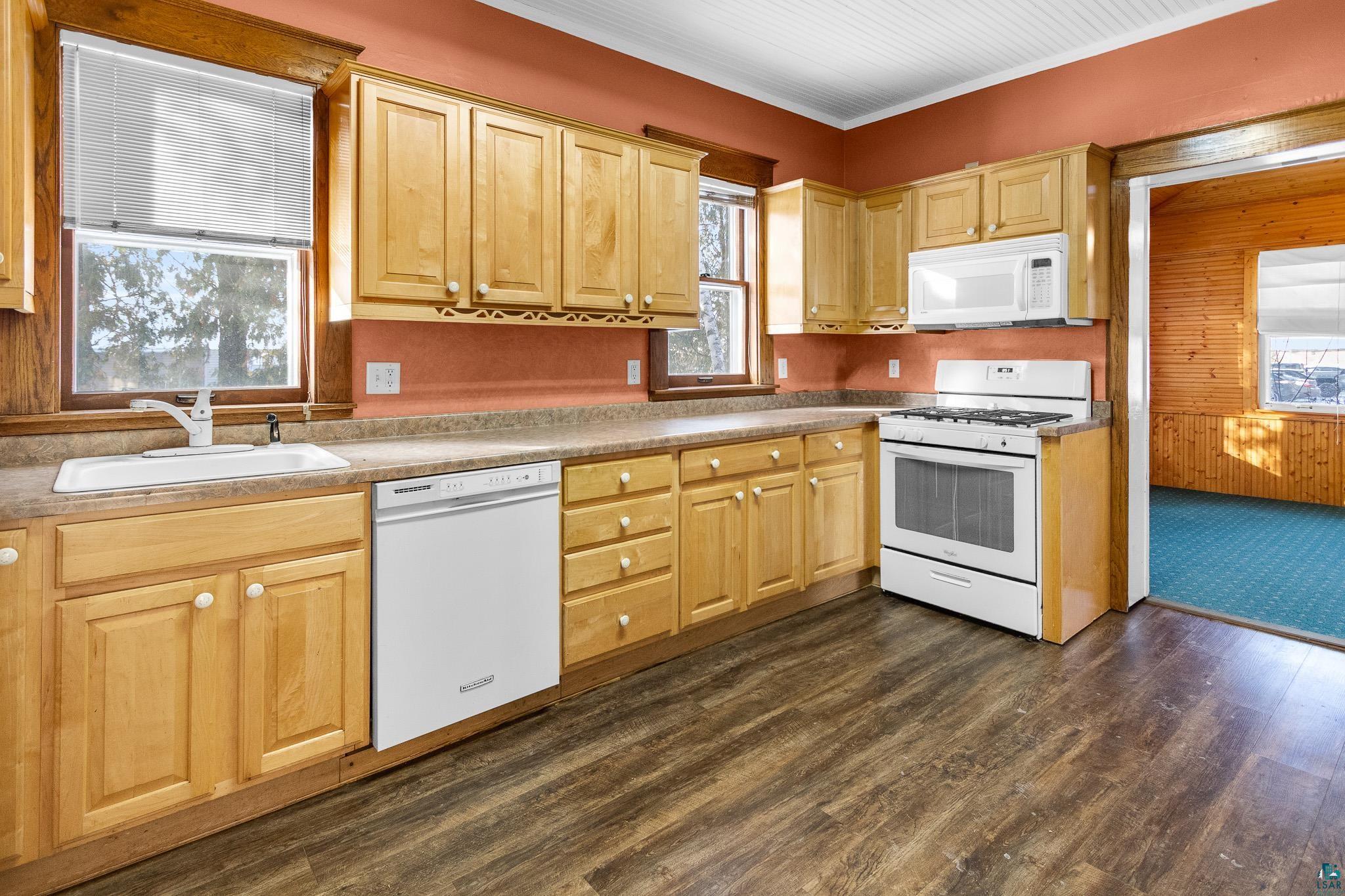 6494 School Street Finlayson, MN 55735 - Photo 4 of 31 Kitchen with white appliances, ornamental molding, dark wood-style flooring, light wood finish cabinets, and light countertops