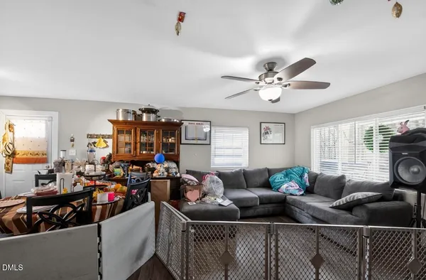 a living room with furniture a fireplace and a window