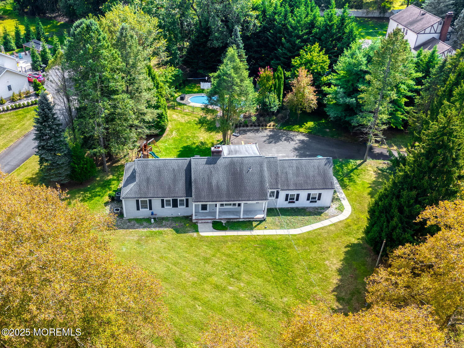 4 Cherry Hill Road Holmdel, NJ 07733 - Photo 30 of 34 a view of a swimming pool with an outdoor space and seating area