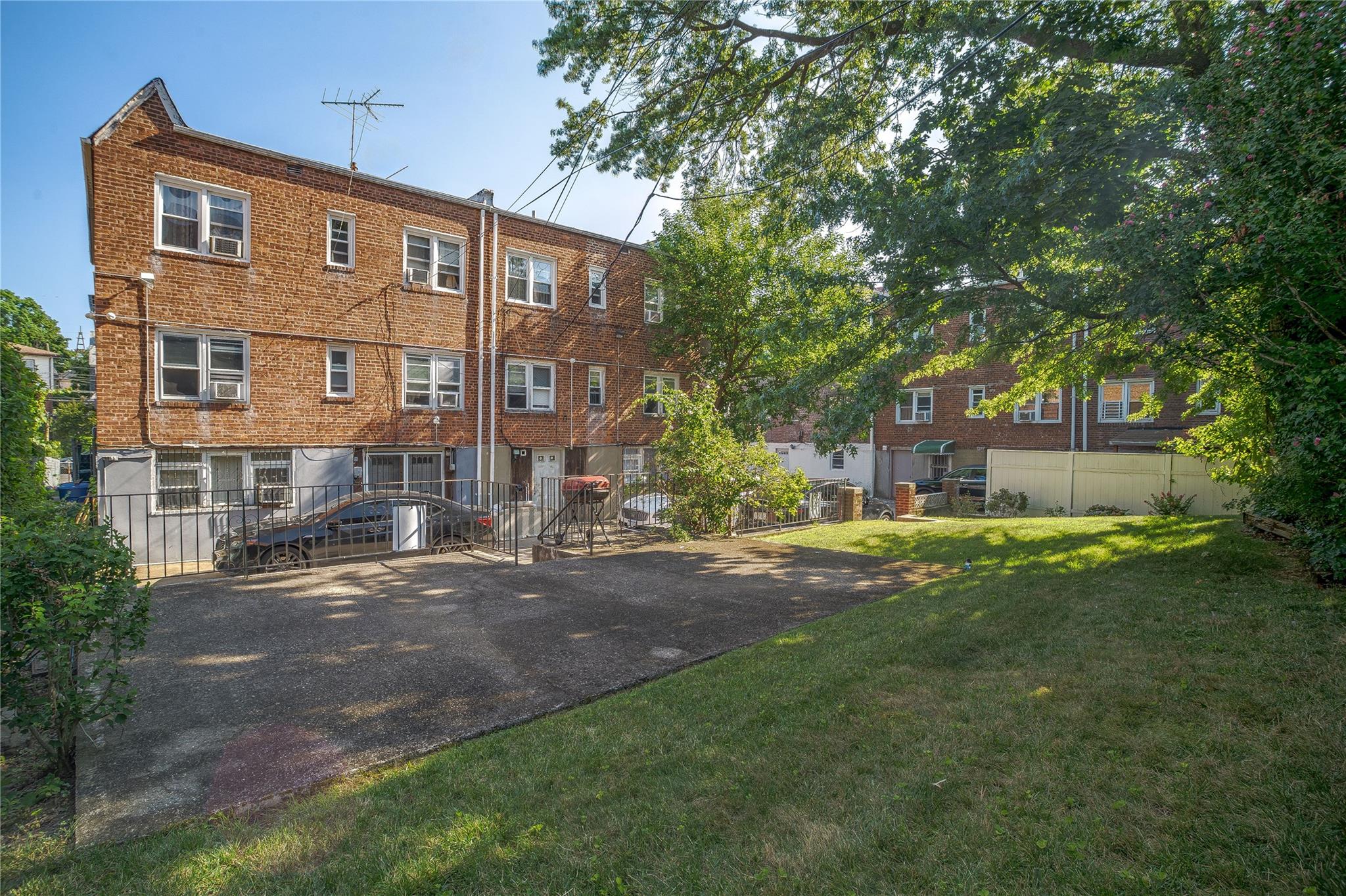 195-11 Woodhull Avenue Queens, NY 11423 - Photo 12 of 13 a front view of a house with a yard
