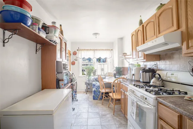 a kitchen with stove and cabinets