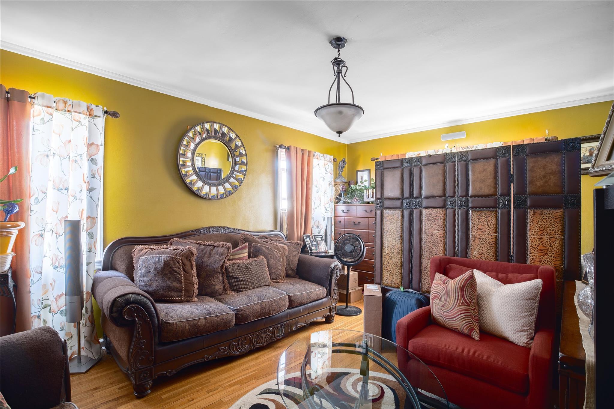 195-11 Woodhull Avenue Queens, NY 11423 - Photo 3 of 13 a living room with furniture a large window and a chandelier