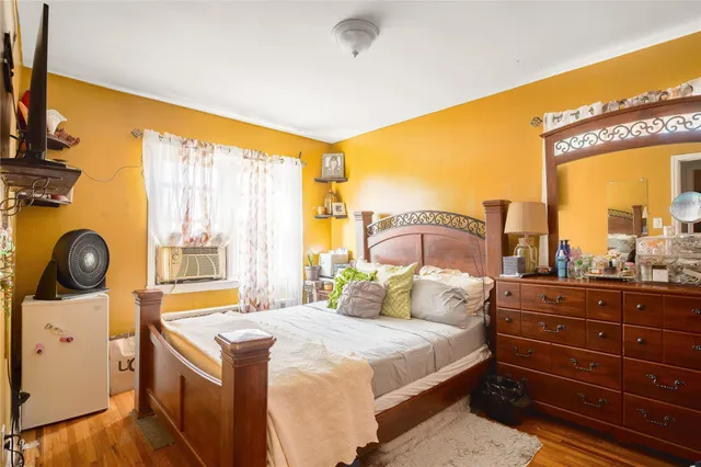 a bedroom with a bed and a large window