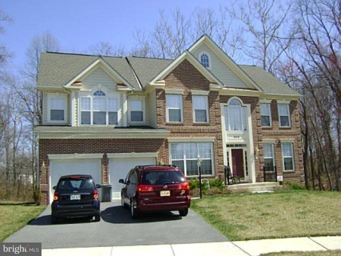 9919 Chessington Way Bowie, MD 20721 - Photo 1 of 1 a front view of a house with a garden
