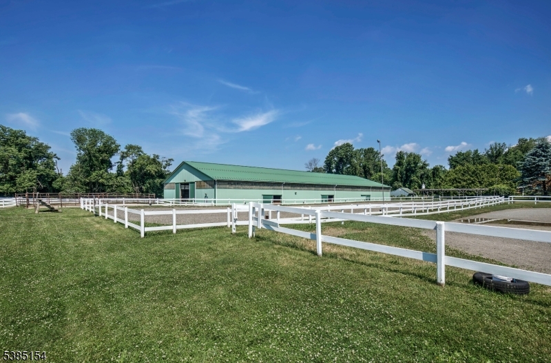 a view of a green field with wooden fence