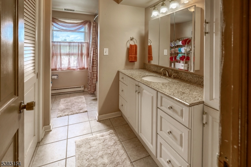245 Old Turnpike Road Califon, NJ 07830 - Photo 27 of 31 a bathroom with a granite countertop sink a mirror and a shower