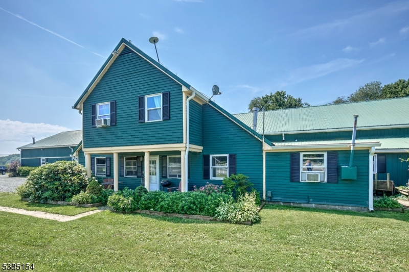 245 Old Turnpike Road Califon, NJ 07830 - Photo 3 of 31 a view of a brick house with a yard
