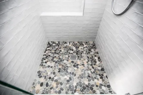 a bathroom with a bathtub and shower