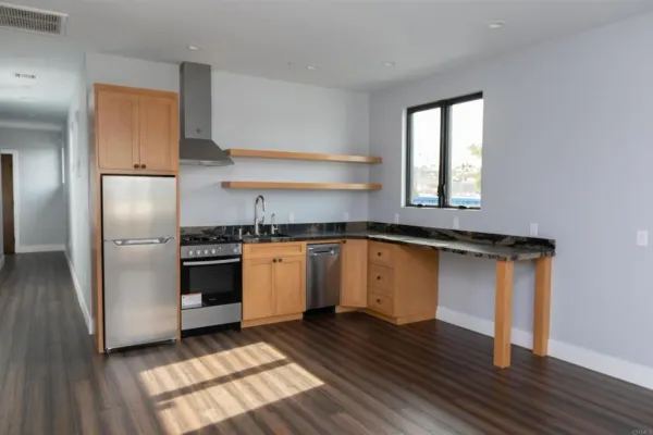 a kitchen with granite countertop a refrigerator and a stove