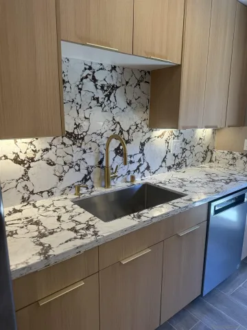 a sink granite counter tops and white stove