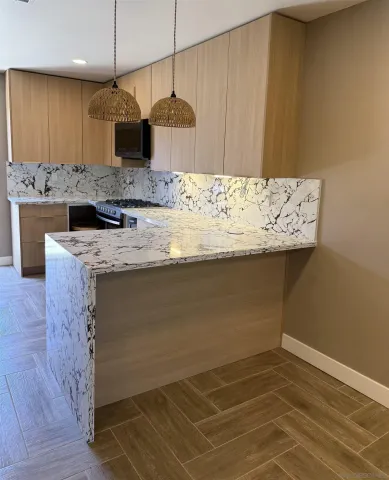 a kitchen with a sink a counter space and cabinets