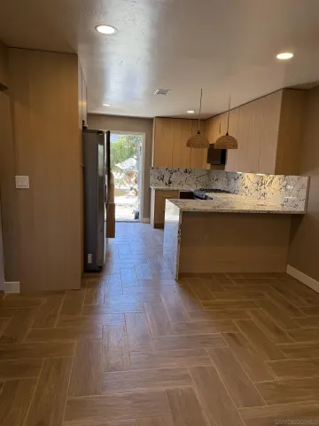 a kitchen with stainless steel appliances granite countertop a sink and a stove