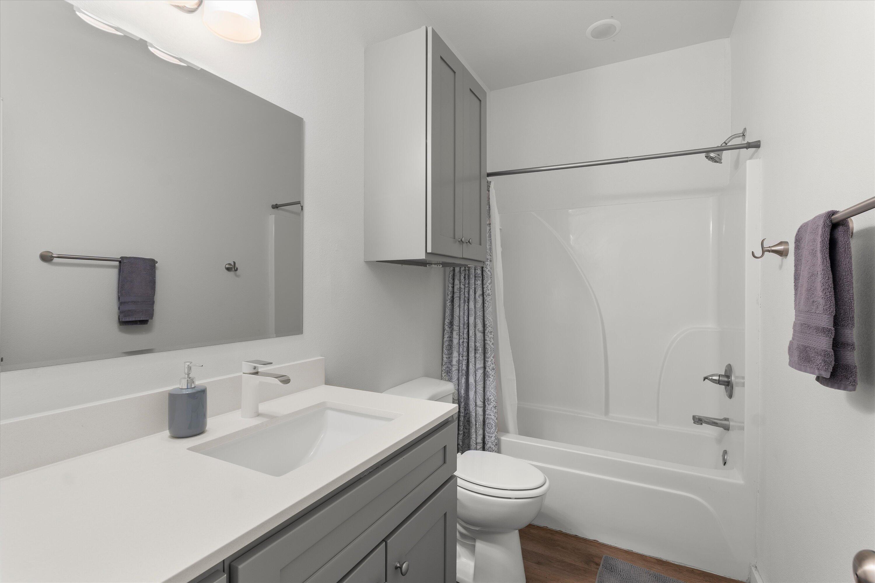 5736 Lehigh Street Lubbock, TX 79416 - Photo 12 of 23 a bathroom with a sink toilet and shower