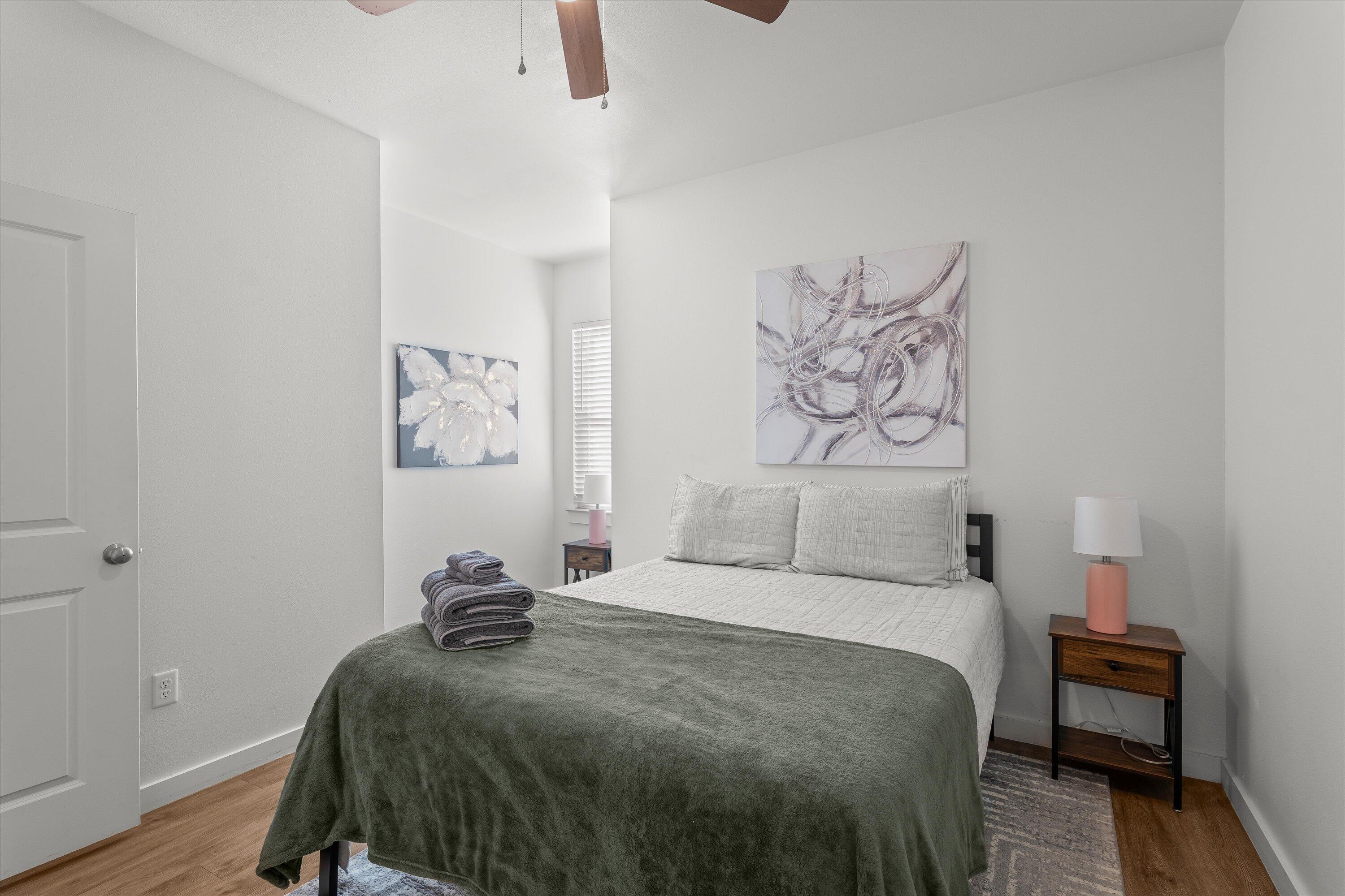 5736 Lehigh Street Lubbock, TX 79416 - Photo 15 of 23 a bedroom with a bed and painting on the wall