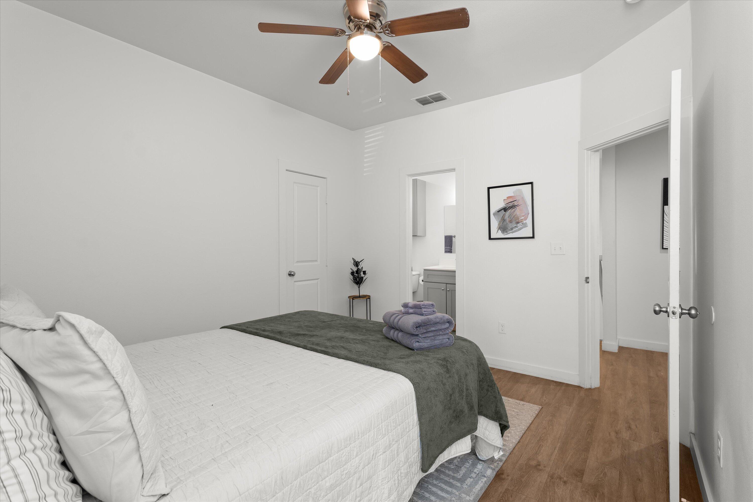 5736 Lehigh Street Lubbock, TX 79416 - Photo 16 of 23 a bedroom with a bed and a chandelier