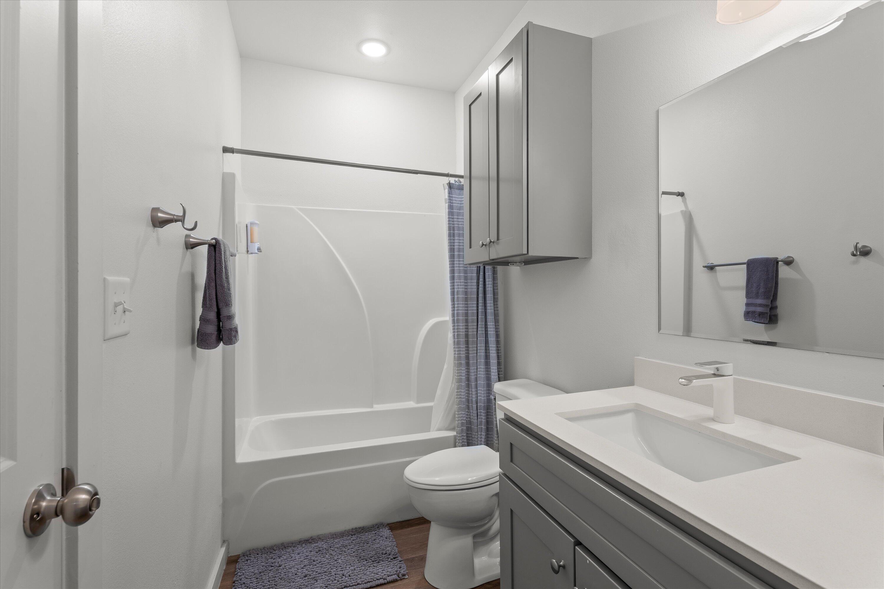 5736 Lehigh Street Lubbock, TX 79416 - Photo 17 of 23 a bathroom with a sink toilet and shower