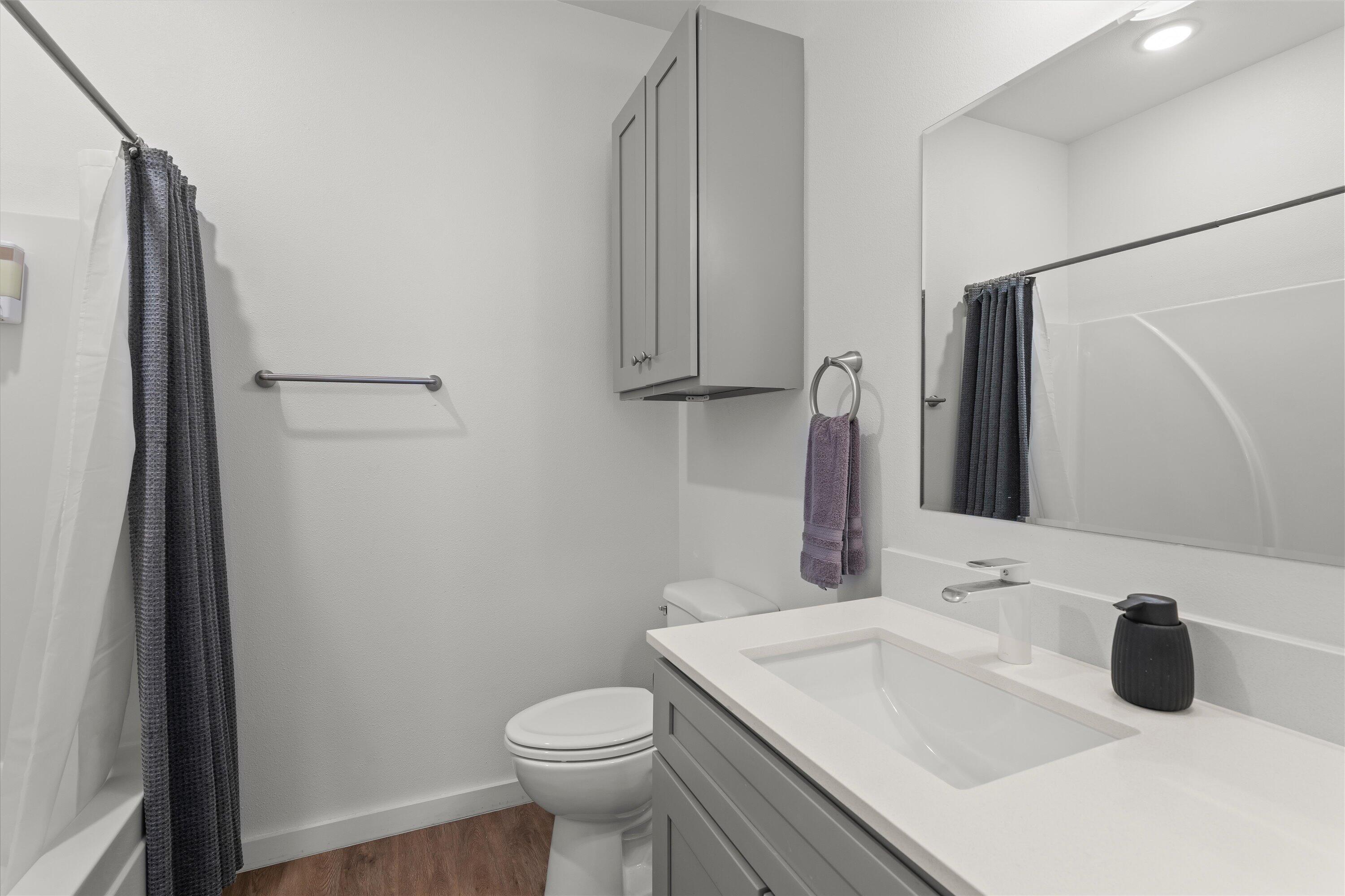 5736 Lehigh Street Lubbock, TX 79416 - Photo 20 of 23 a bathroom with a sink toilet and mirror