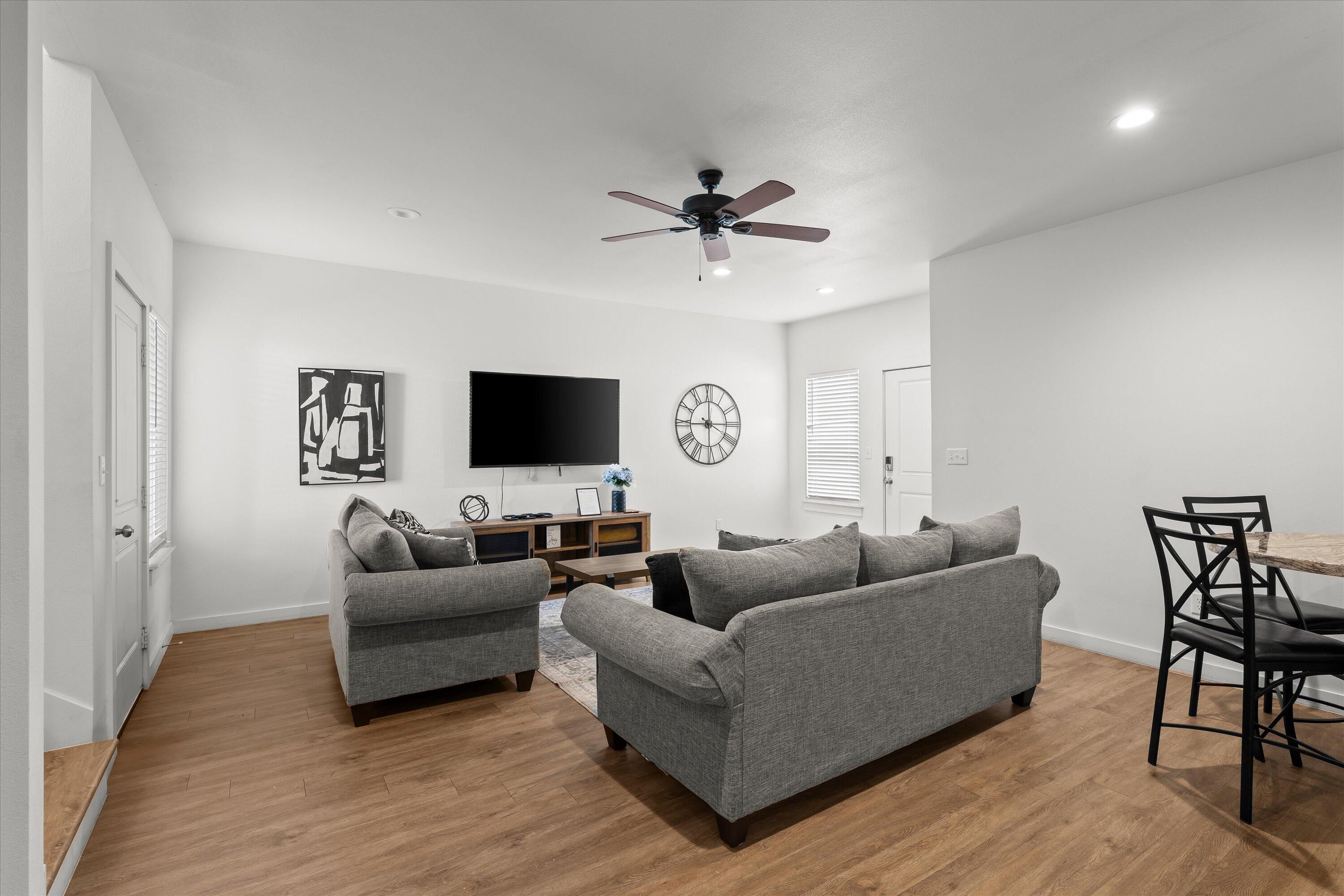 5736 Lehigh Street Lubbock, TX 79416 - Photo 5 of 23 a living room with furniture and a flat screen tv
