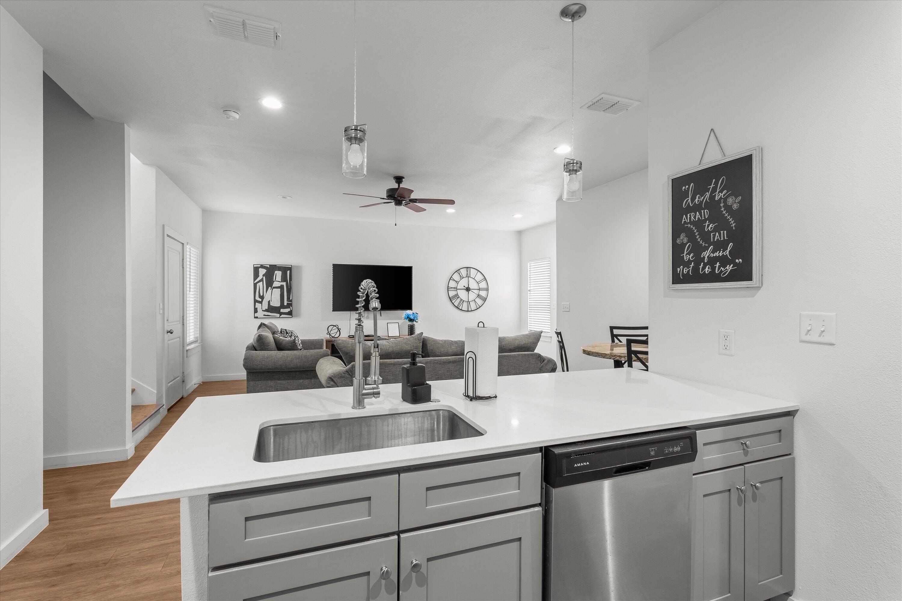 5736 Lehigh Street Lubbock, TX 79416 - Photo 8 of 23 a kitchen with a sink and a refrigerator
