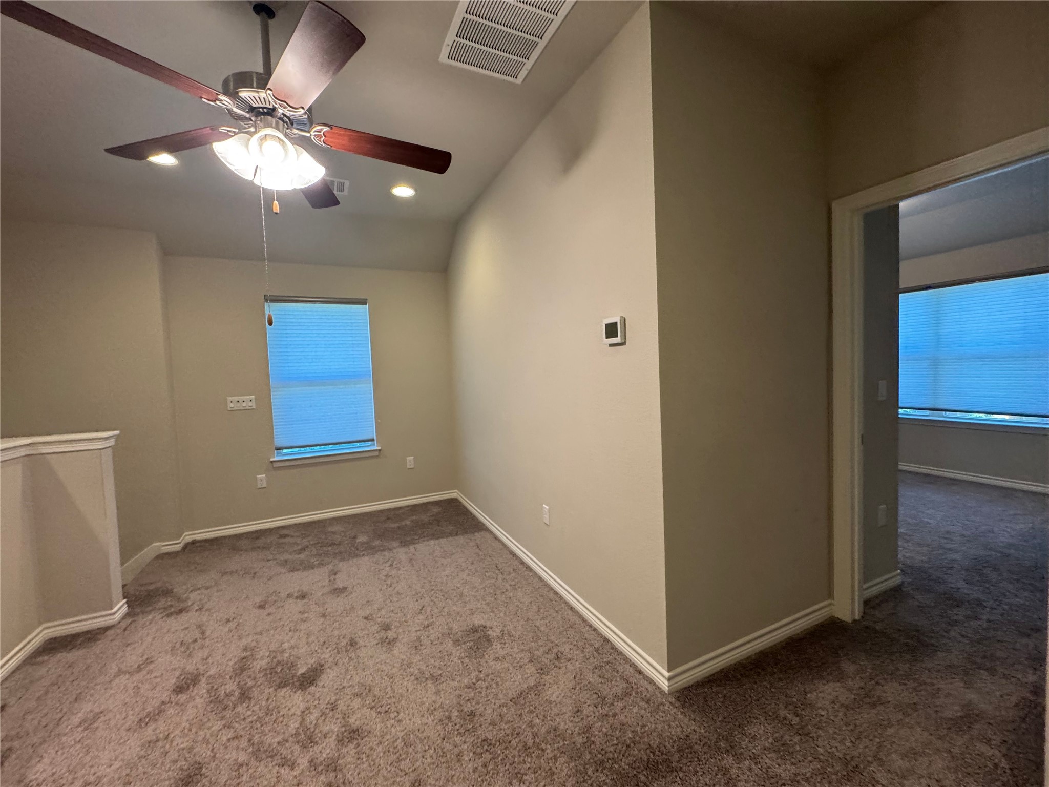 14100 McCoy Loop, Unit 1 Austin, TX 78717 - Photo 32 of 39 A versatile bonus space offers ample natural light and plush carpeting, perfect for relaxation or a home office.