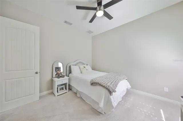 a kitchen with stainless steel appliances granite countertop a refrigerator a stove and white cabinets